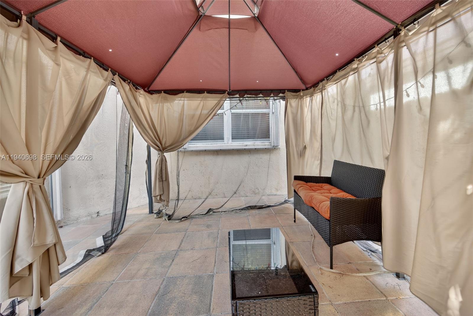 367 Northeast 36th Avenue Road Homestead, FL 33033 - Photo 32 of 36 a yellow room with a couch and a table