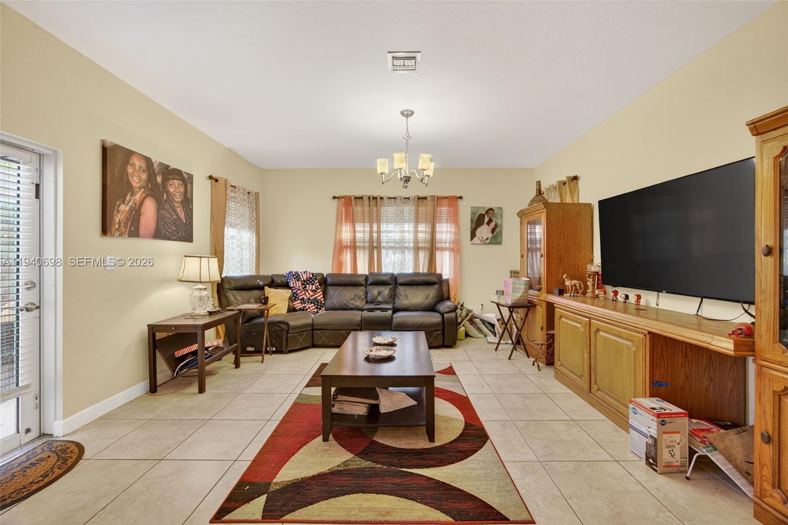 367 Northeast 36th Avenue Road Homestead, FL 33033 - Photo 8 of 36 a living room with furniture and a flat screen tv