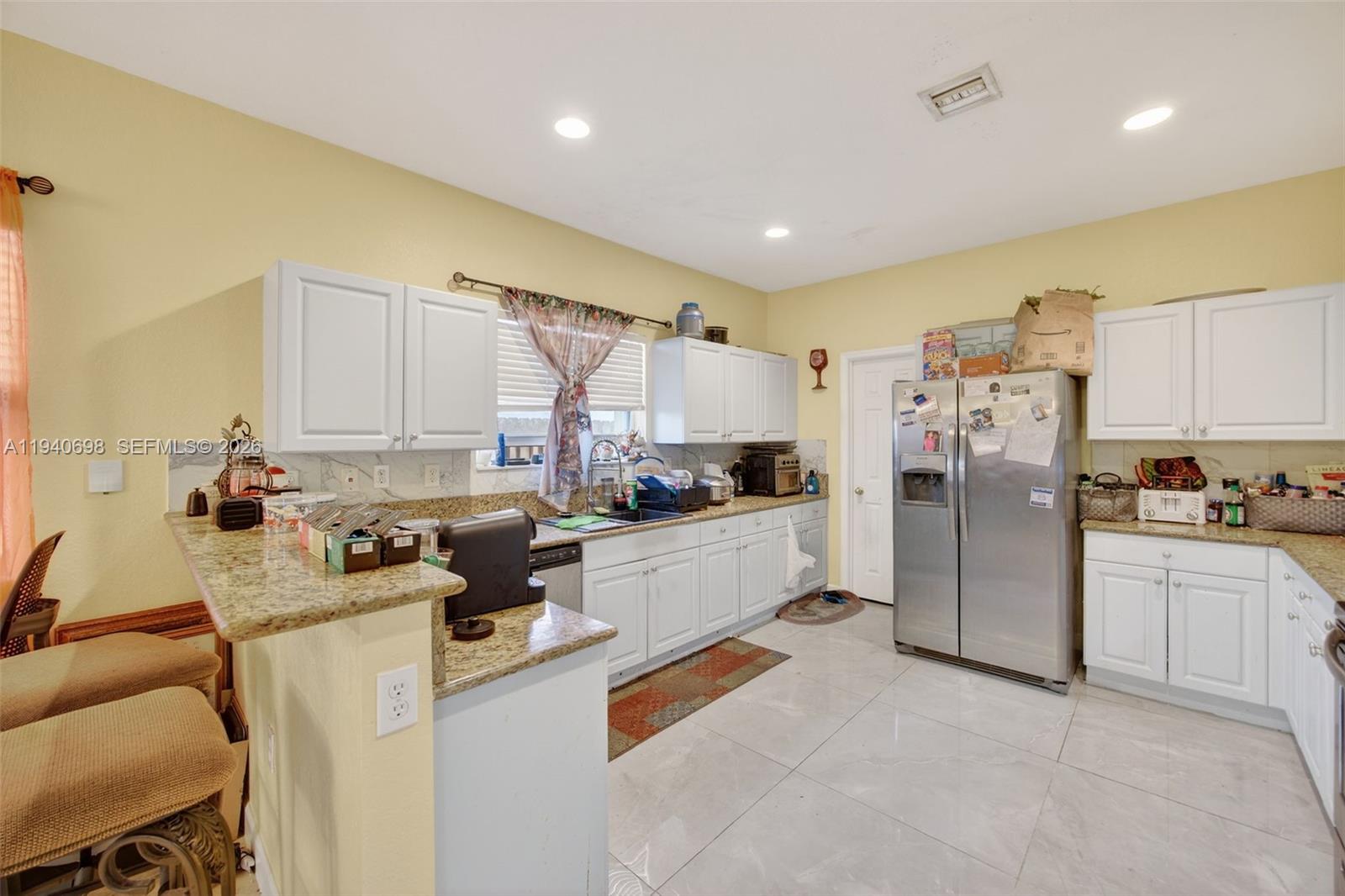 367 Northeast 36th Avenue Road Homestead, FL 33033 - Photo 10 of 36 a kitchen that has a lot of cabinets and refrigerator