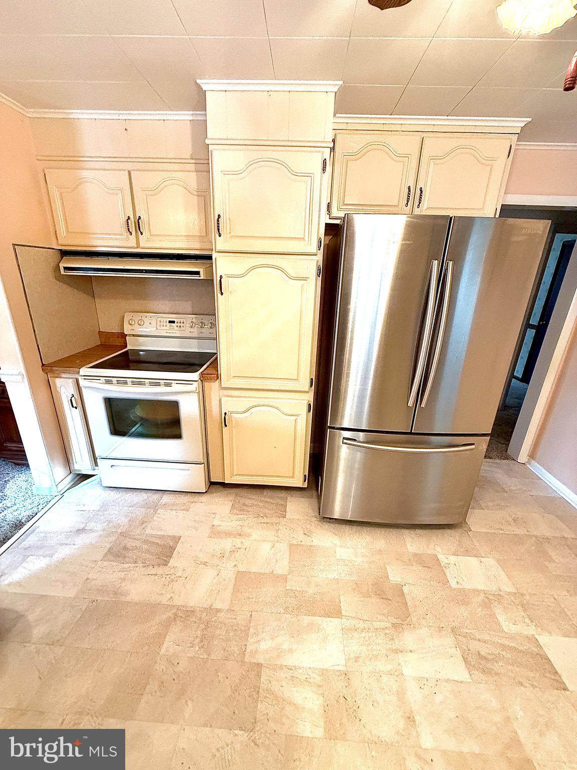 320 South Bonsall Road Coatesville, PA 19320 - Photo 16 of 36 a view of a refrigerator in kitchen and wooden floor