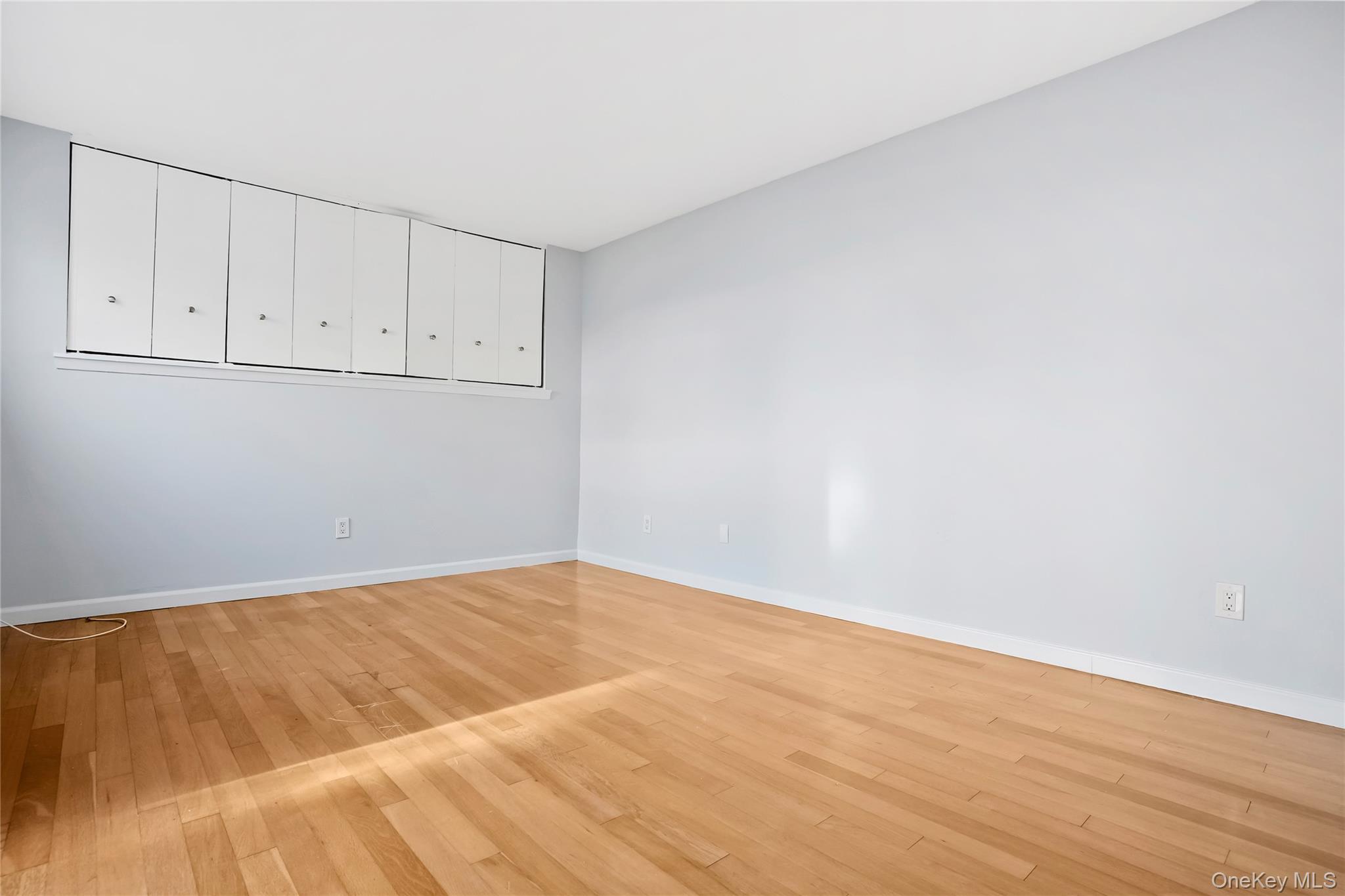 208 Harris Road, Unit HA3 Bedford, NY 10507 - Photo 14 of 41 Unfurnished room with light wood-style flooring and baseboards