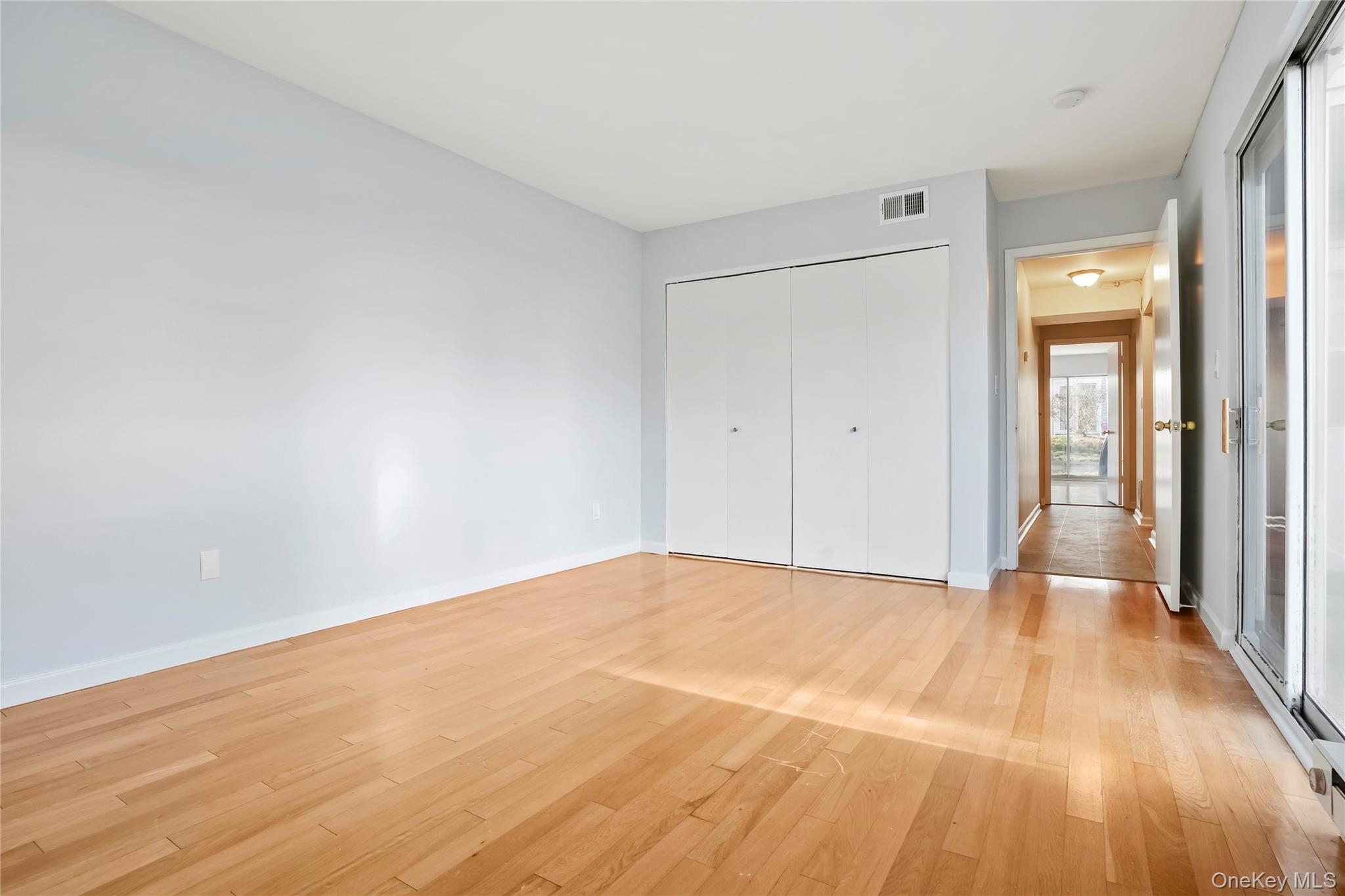 208 Harris Road, Unit HA3 Bedford, NY 10507 - Photo 15 of 41 Unfurnished bedroom featuring light wood-style floors and a closet