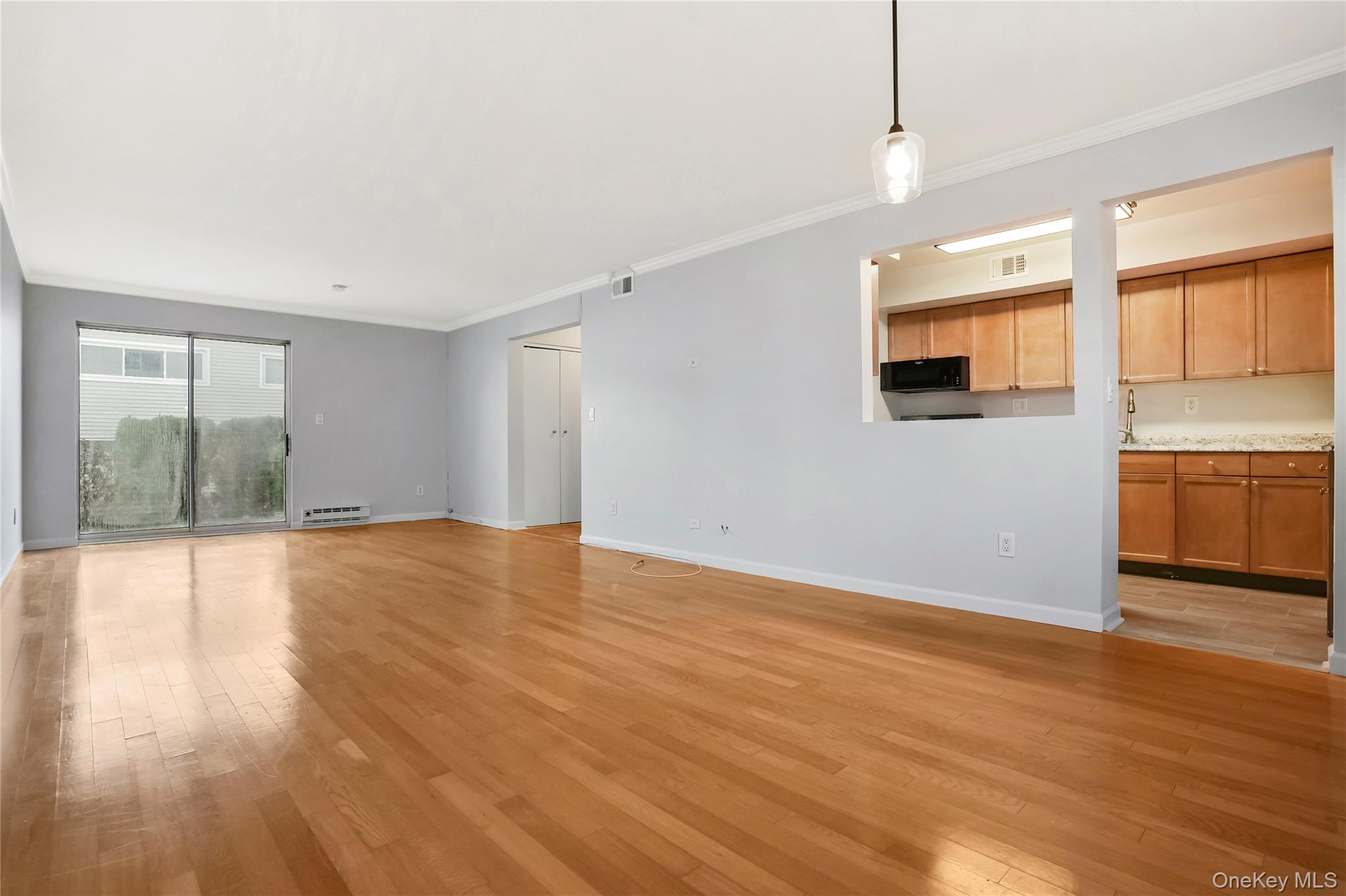 208 Harris Road, Unit HA3 Bedford, NY 10507 - Photo 33 of 41 Unfurnished living room with light wood-style flooring and crown molding