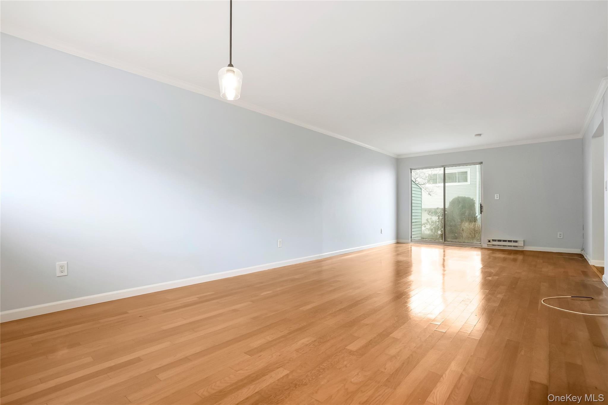 208 Harris Road, Unit HA3 Bedford, NY 10507 - Photo 34 of 41 Unfurnished room with wood finished floors, ornamental molding, and baseboard heating