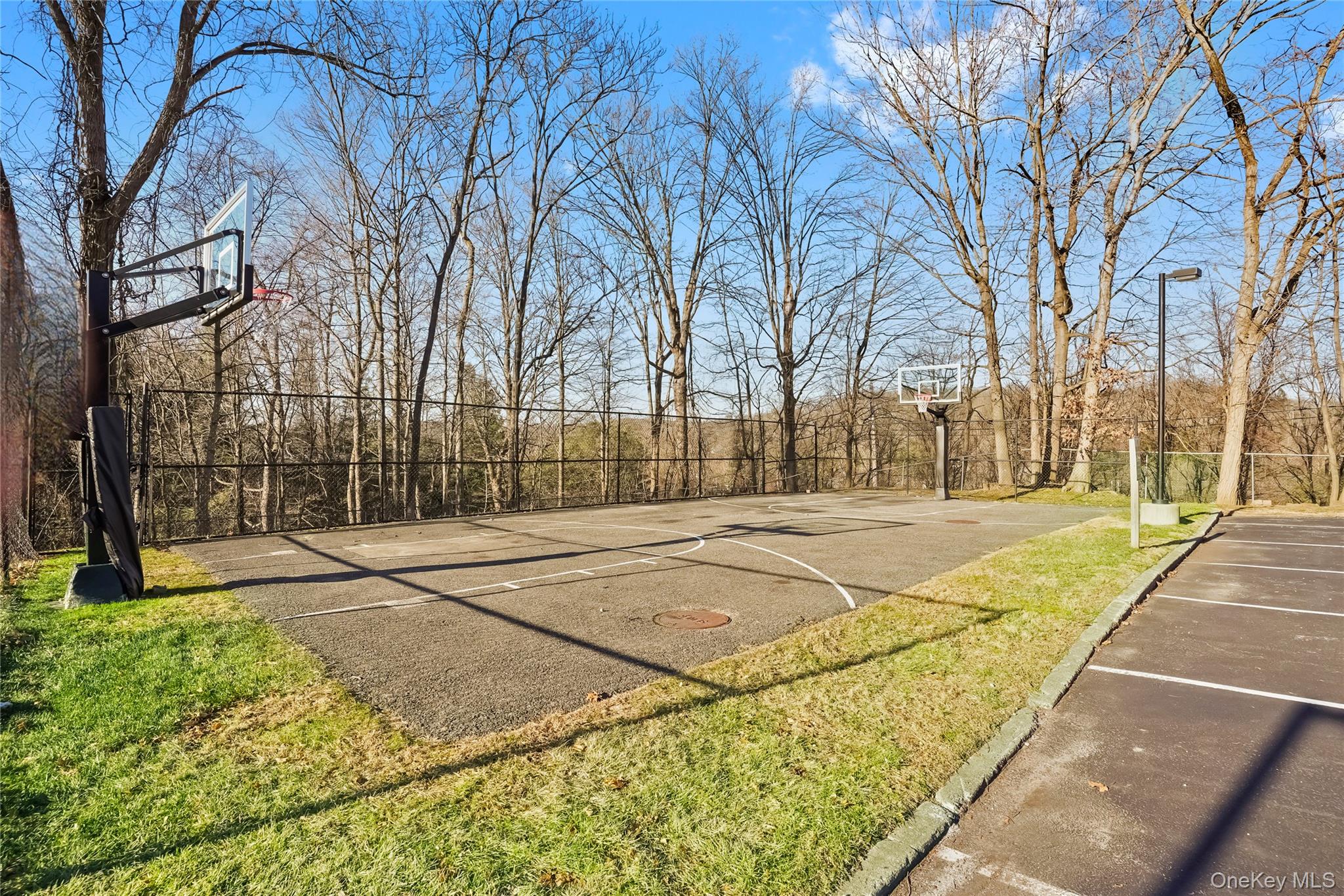 208 Harris Road, Unit HA3 Bedford, NY 10507 - Photo 40 of 41 View of basketball court featuring basketball hoop and a patio area