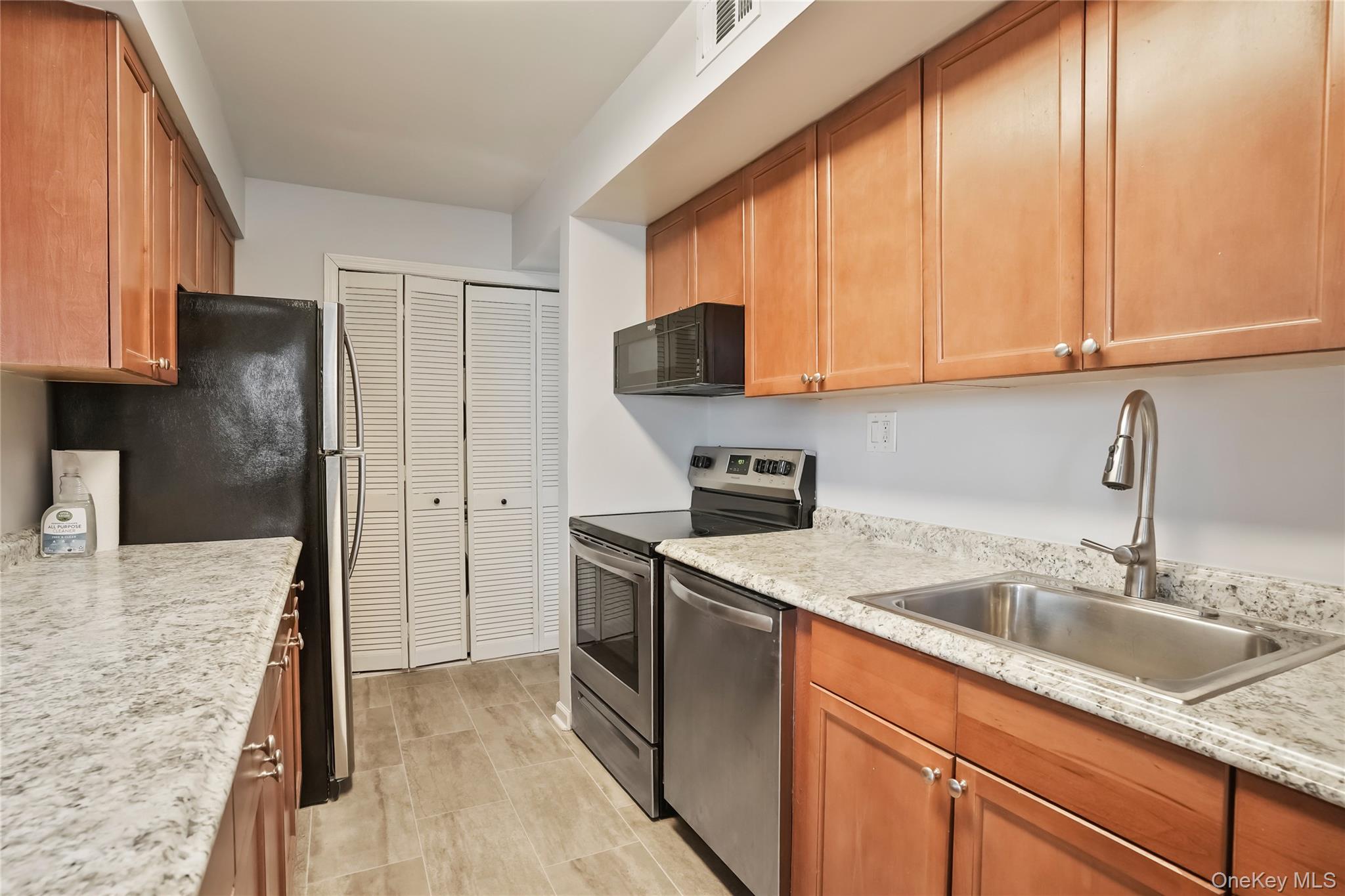 208 Harris Road, Unit HA3 Bedford, NY 10507 - Photo 8 of 41 Kitchen featuring stainless steel appliances and brown cabinets