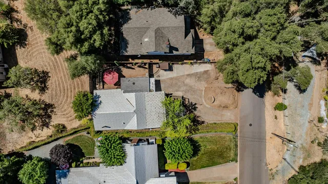 an aerial view of a house with a yard basket ball court and outdoor seating