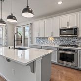a kitchen with sink a stove and microwave