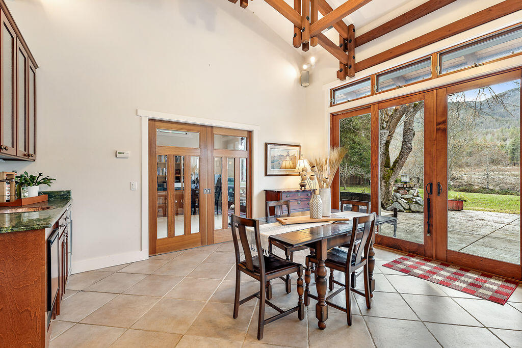 3828 Upper Applegate Road Jacksonville, OR 97530 - Photo 34 of 69 a dining room with furniture and large windows