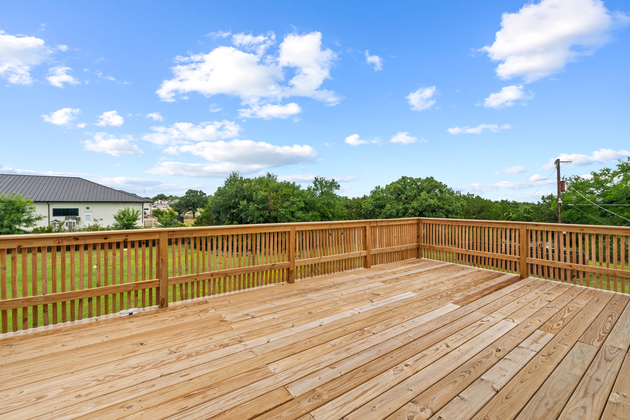 205 Sedro Trail Georgetown, TX 78633 - Photo 6 of 32 A spacious wooden deck provides elevated outdoor living with serene views of natural surroundings.