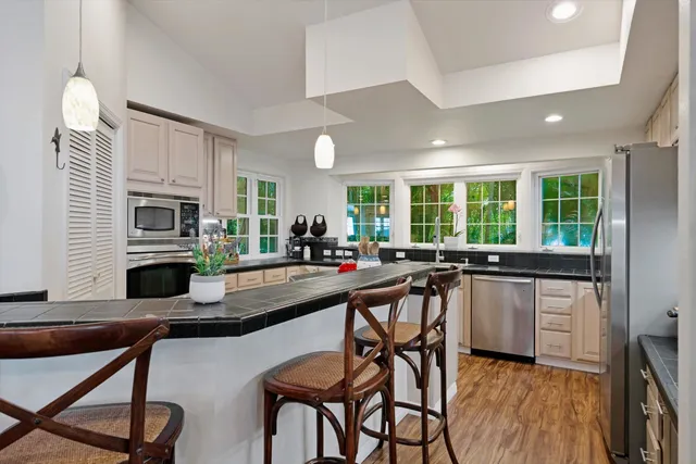 a kitchen with a table chairs microwave and cabinets