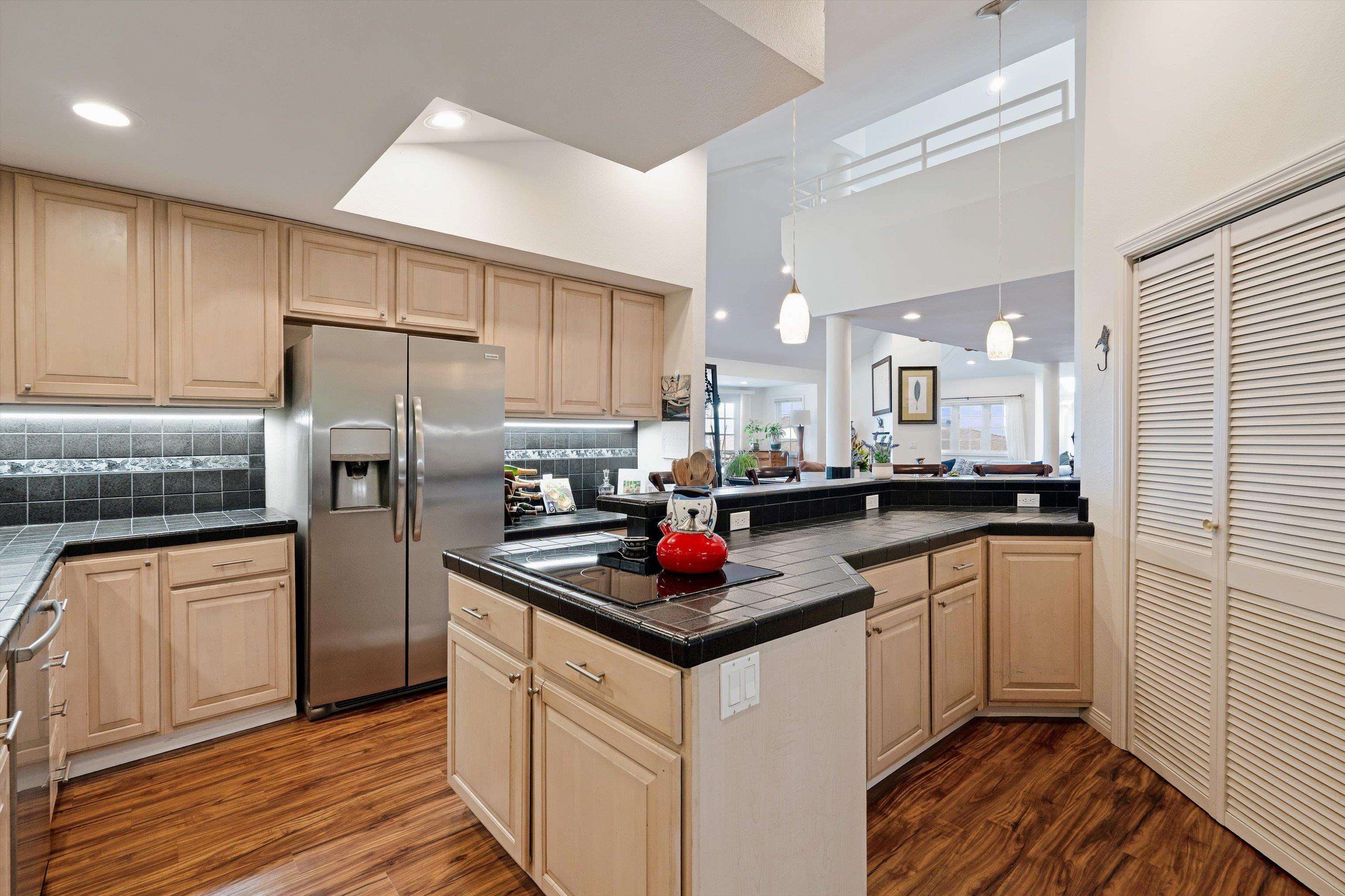 571 South Alu Road Wailuku, HI 96793 - Photo 14 of 49 a kitchen with stainless steel appliances granite countertop a refrigerator sink and cabinets