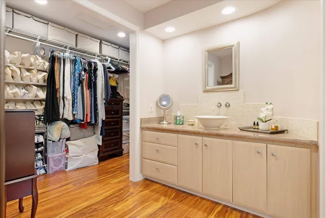 a bathroom with a sink mirror and a shower