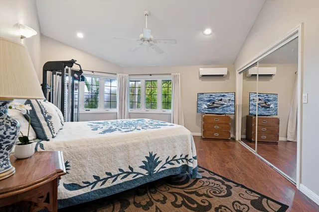 a bed room with a bed window and a television