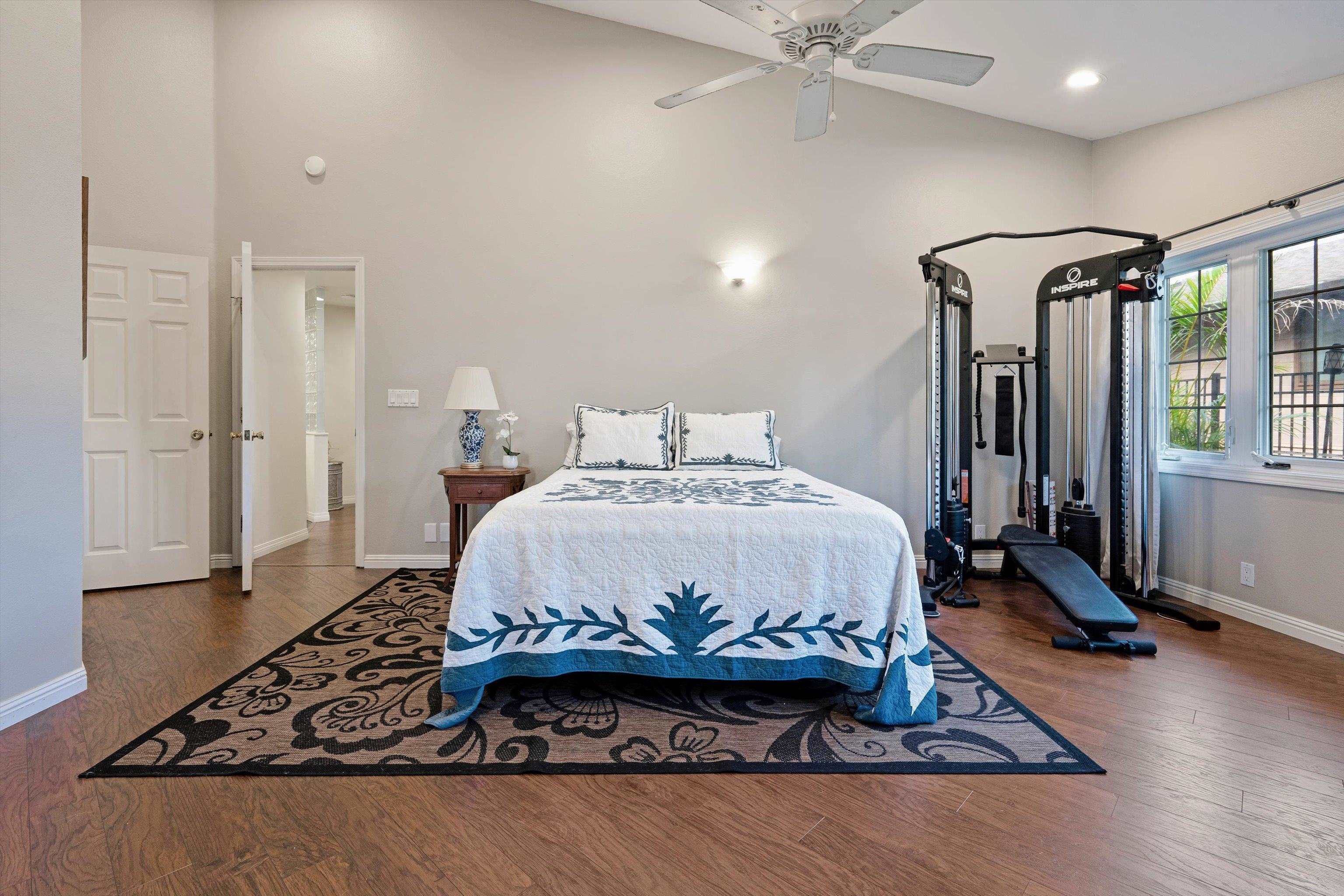 571 South Alu Road Wailuku, HI 96793 - Photo 27 of 49 a bedroom with a bed and wooden floor