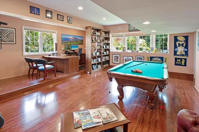 a living room with furniture a flat screen tv and wooden floor