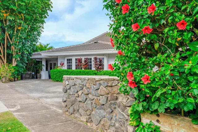 a house with flowers in front of it