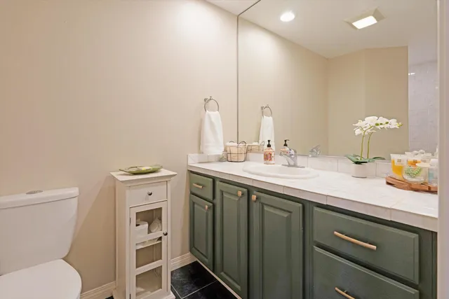a bathroom with a toilet sink and mirror