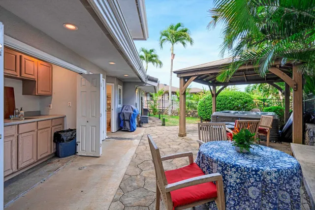 a view of a patio with table and chairs potted plants with wooden fence