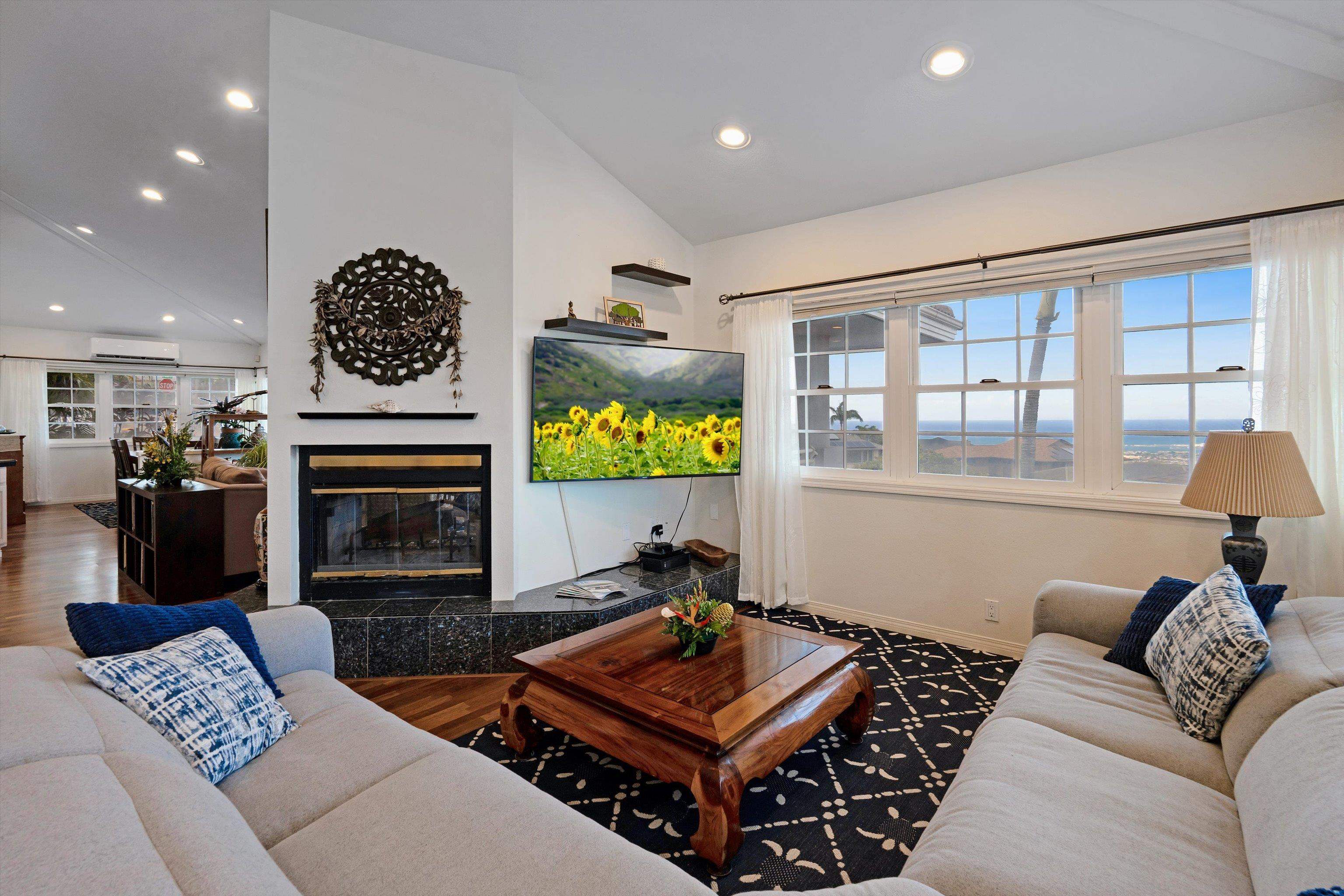 571 South Alu Road Wailuku, HI 96793 - Photo 8 of 49 a living room with furniture a flat screen tv and a fireplace