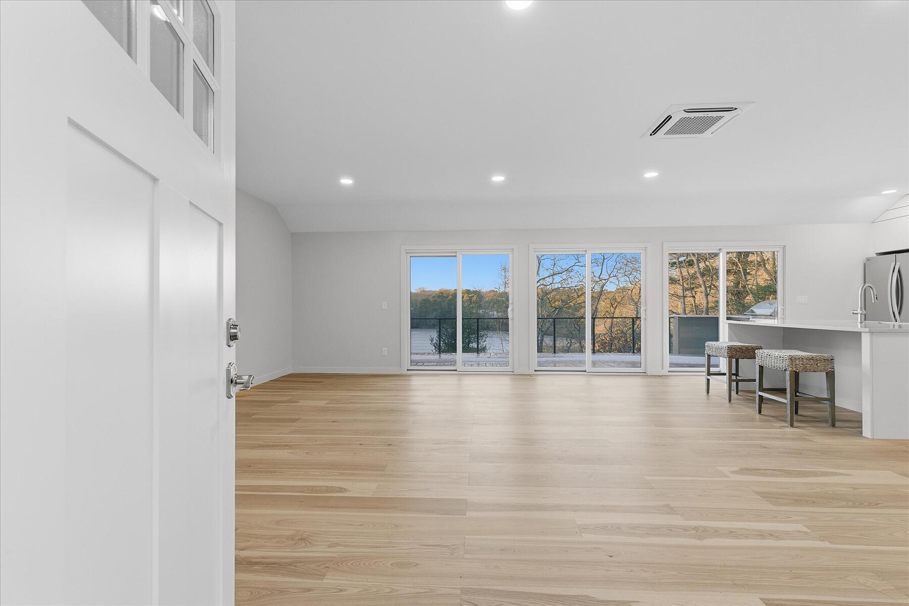 162 Main Street Osterville, MA 02655 - Photo 14 of 47 a view of an empty room with wooden floor and a window