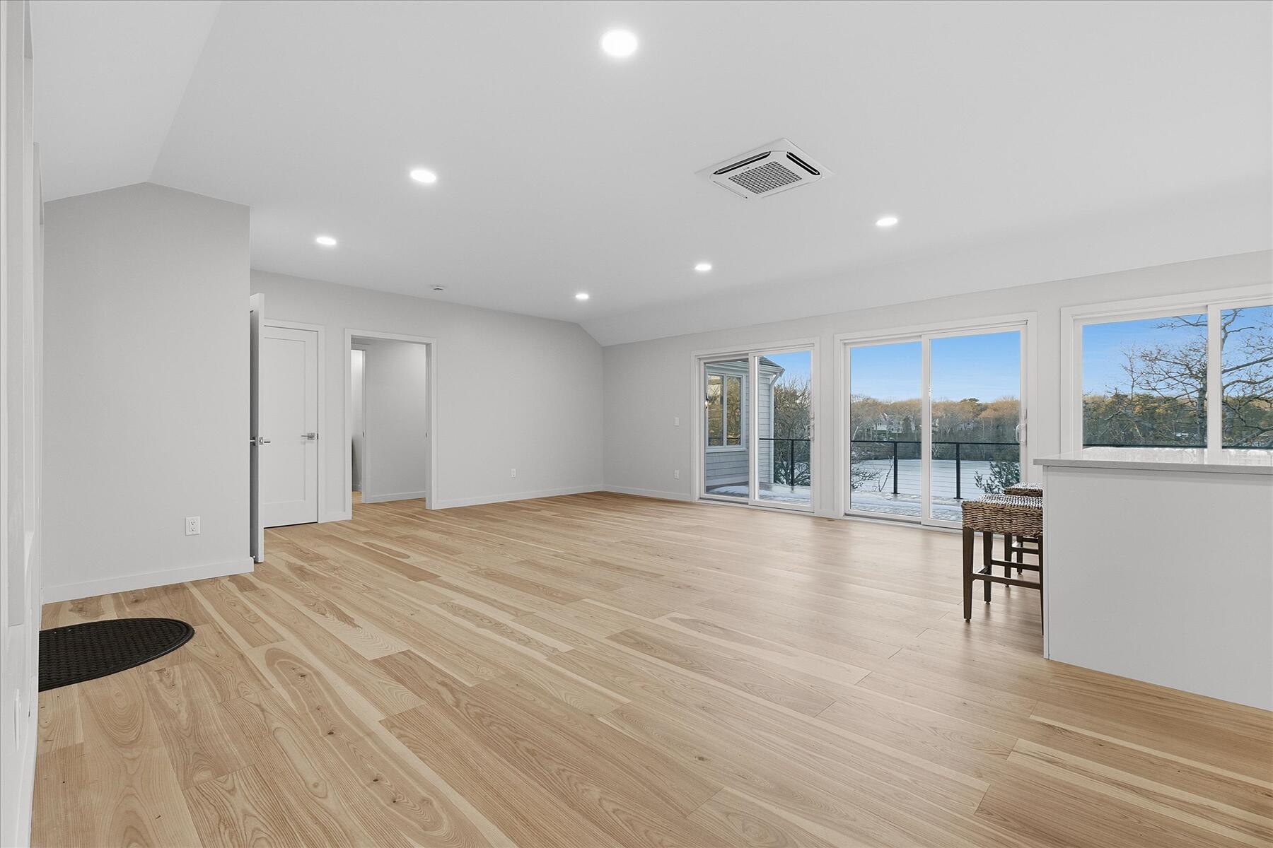 162 Main Street Osterville, MA 02655 - Photo 8 of 47 a view of an empty room with a window and wooden floor