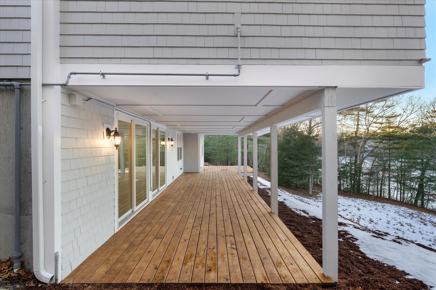 162 Main Street Osterville, MA 02655 - Photo 10 of 47 a view of backyard with large trees and wooden fence