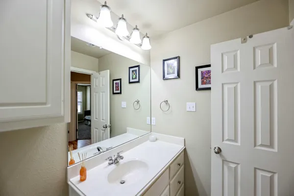 a bathroom with a sink vanity and a mirror