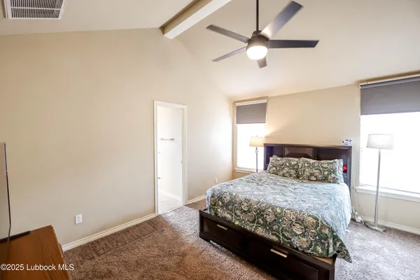 a bedroom with a bed and a ceiling fan