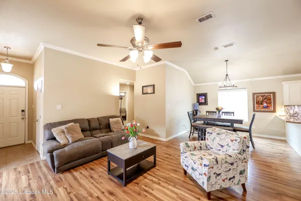 a living room with furniture and a chandelier