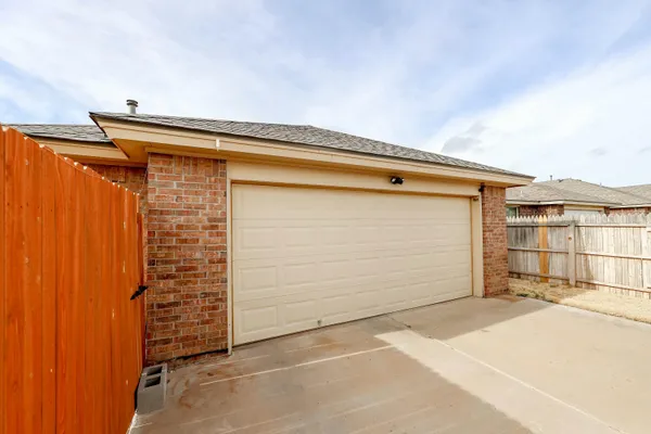 a view of a house with backyard and parking space
