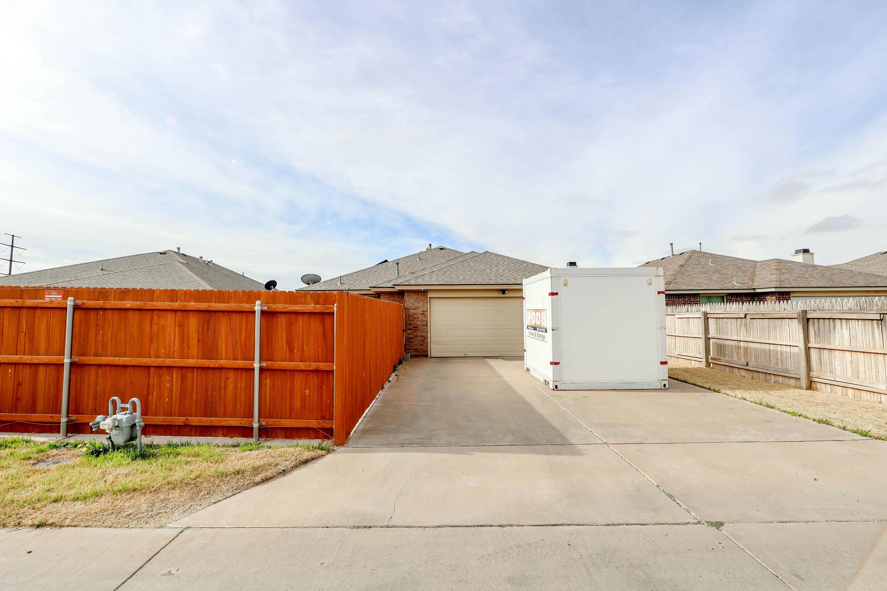 5920 104th Street Lubbock, TX 79424 - Photo 25 of 26 a view of a house with backyard and parking space