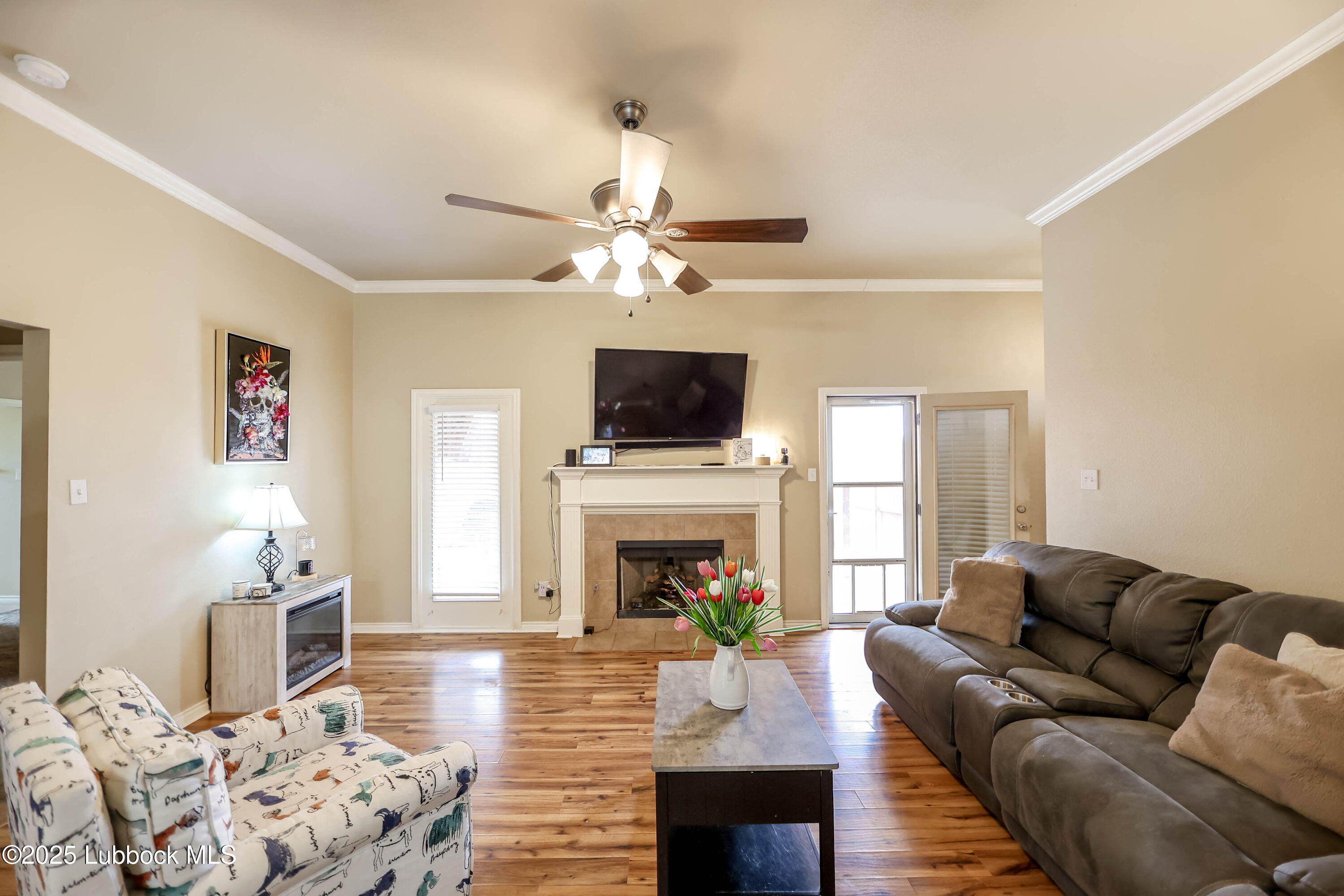 5920 104th Street Lubbock, TX 79424 - Photo 3 of 26 a living room with furniture a fireplace and a flat screen tv