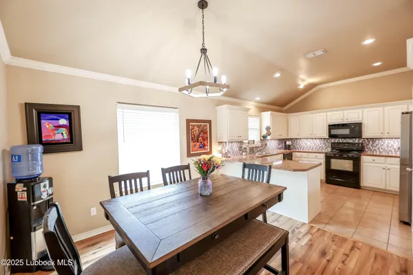 a view of a dining room with furniture and a chandelier
