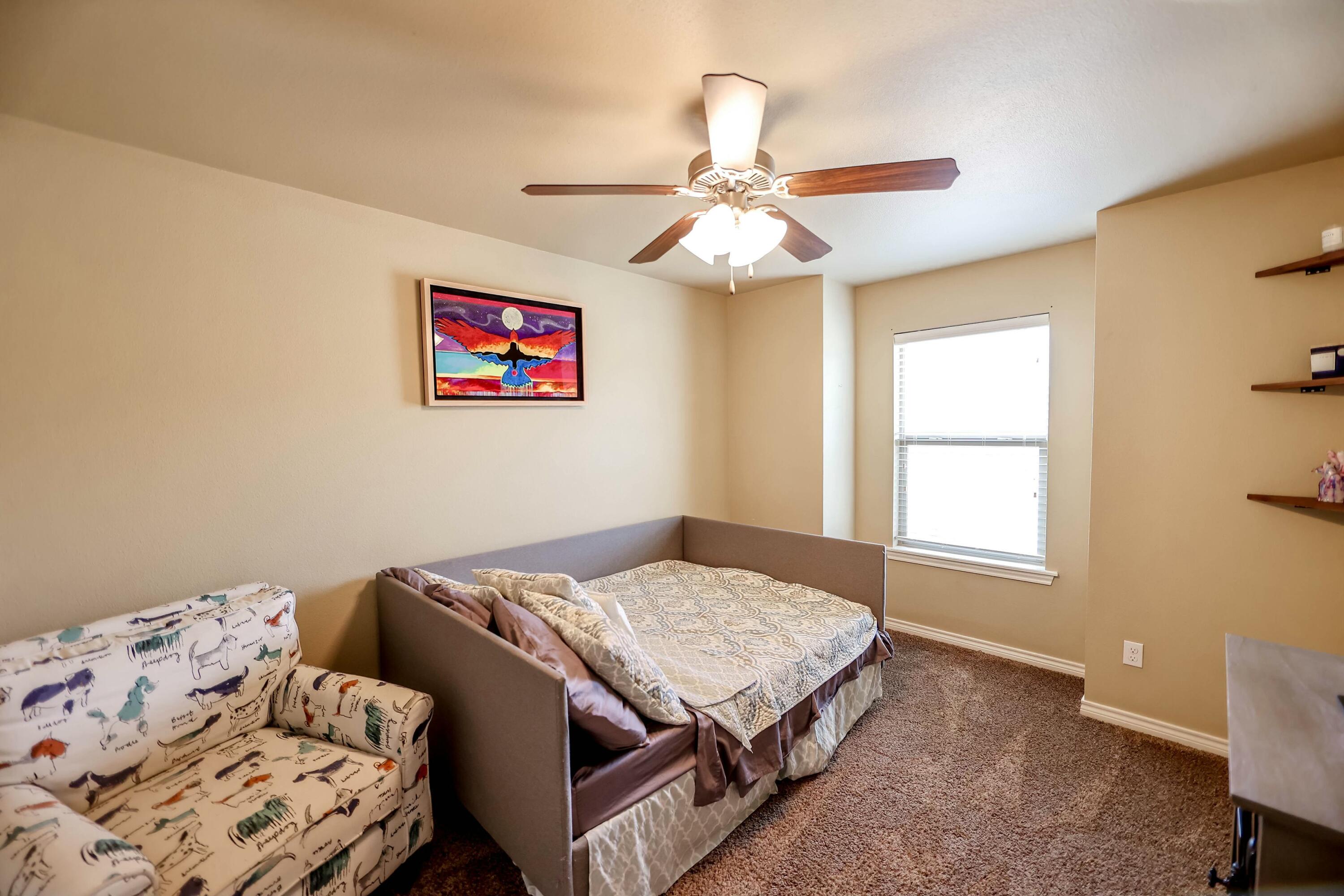 5920 104th Street Lubbock, TX 79424 - Photo 7 of 26 a bedroom with a bed and a window