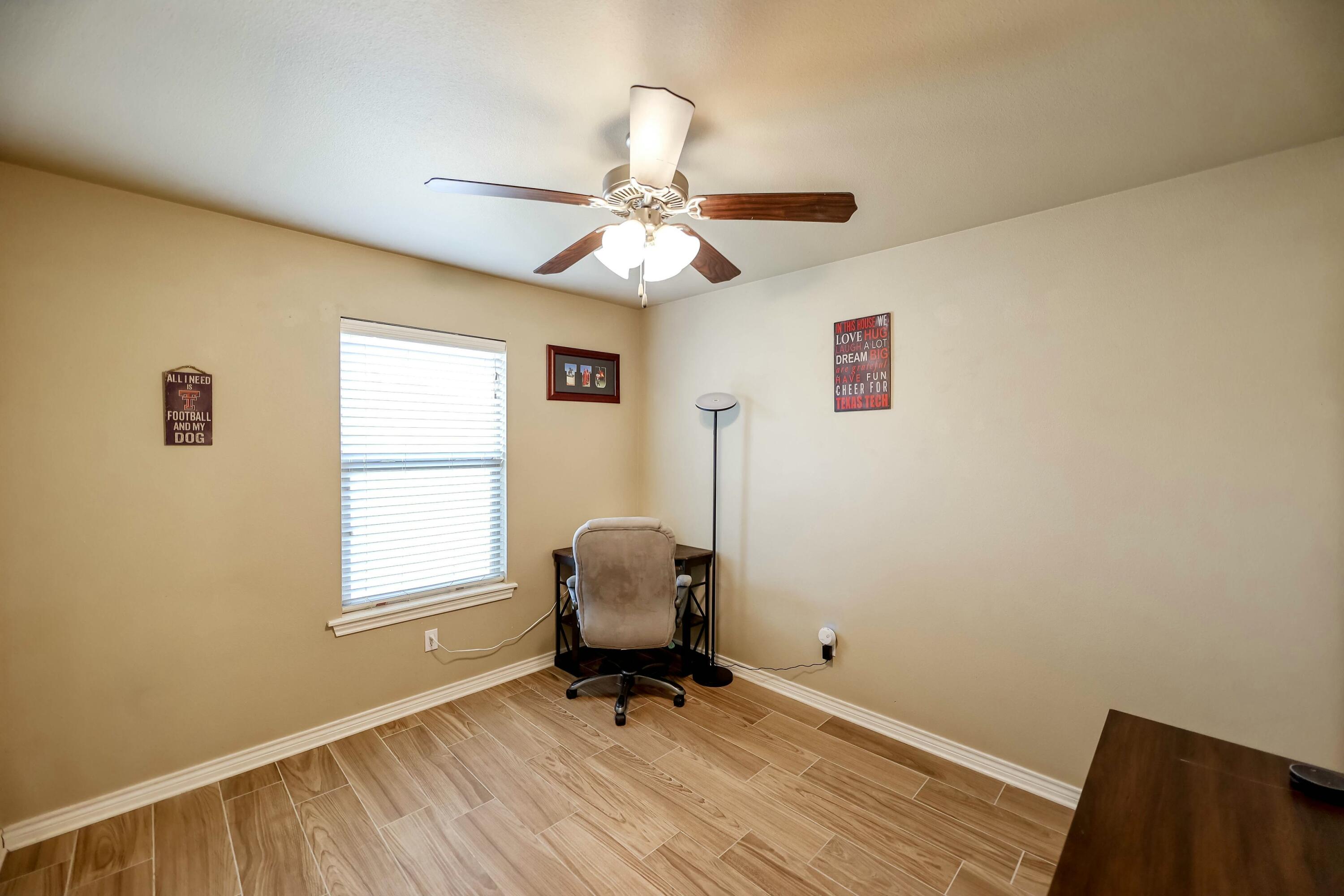 5920 104th Street Lubbock, TX 79424 - Photo 10 of 26 a view of workspace with wooden floor and windows