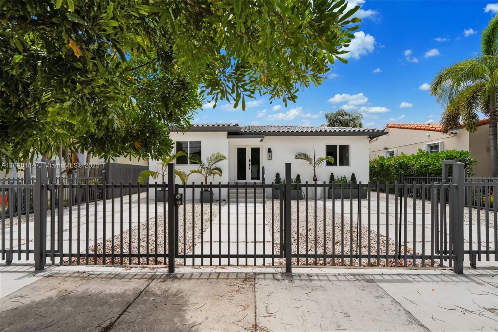 a view of a house with a small yard and wooden fence
