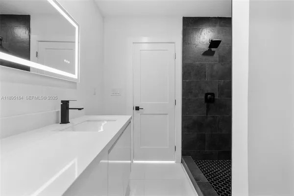 a bathroom with a sink and a shower