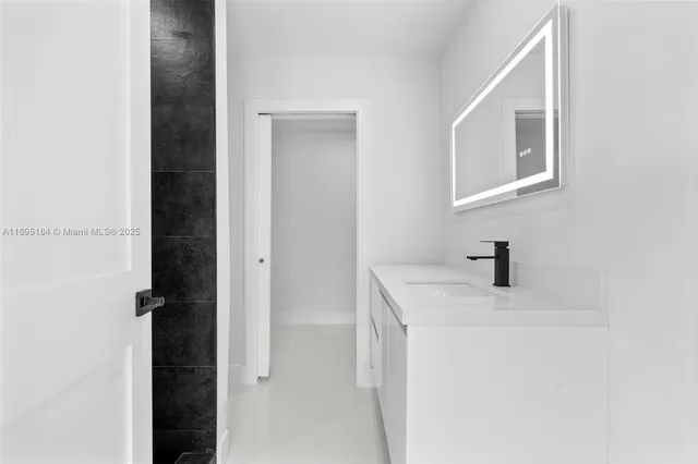 a bathroom with a sink vanity and a mirror