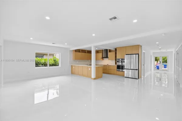 a view of kitchen with stainless steel appliances granite countertop sink and cabinets