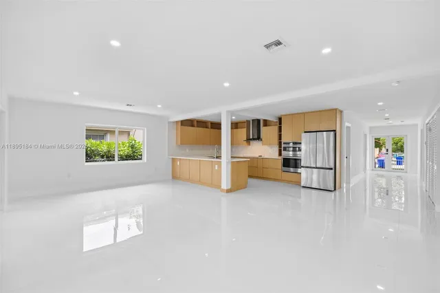 a view of kitchen with stainless steel appliances granite countertop sink and cabinets