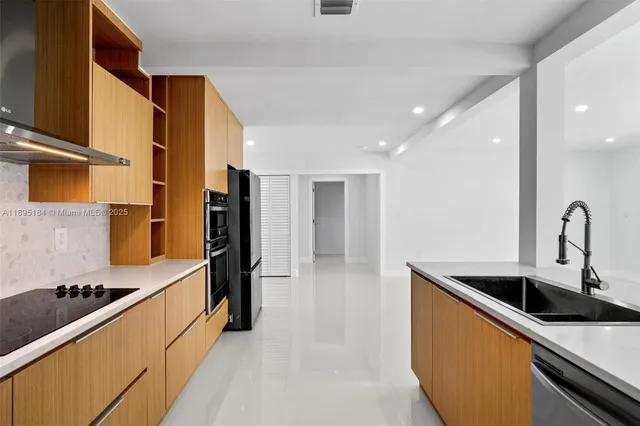 a kitchen with a sink and cabinets