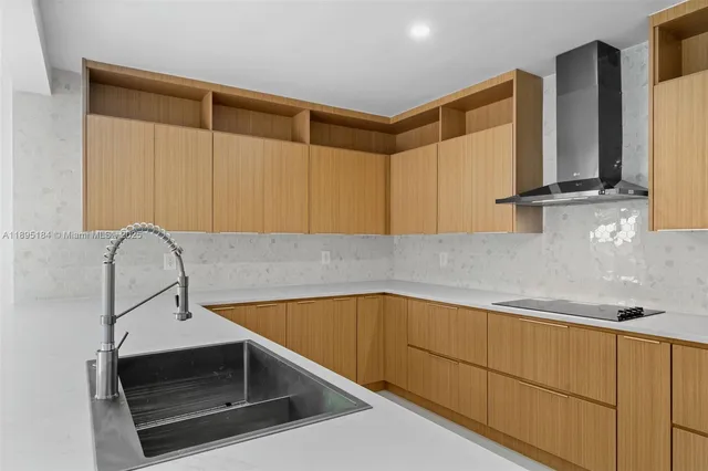 a kitchen with stainless steel appliances a refrigerator sink and cabinets