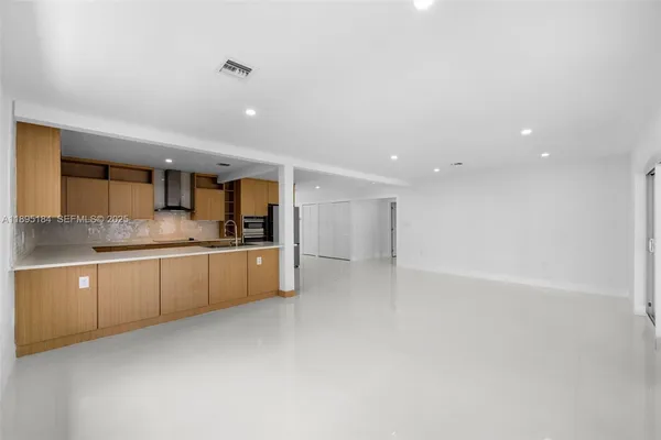 a kitchen with stainless steel appliances a refrigerator and a stove top oven