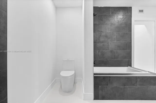 a bathroom with a bathtub and a sink