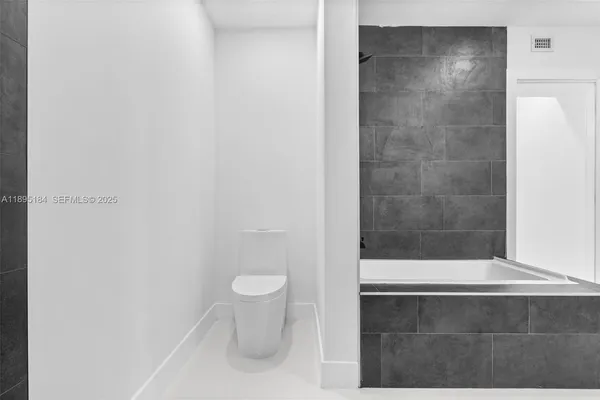 a bathroom with a bathtub and a sink