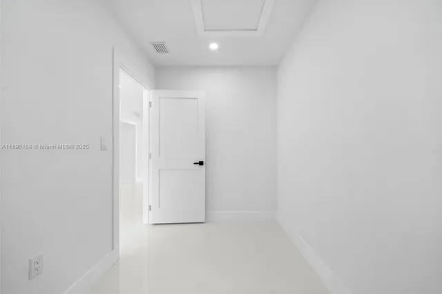 an empty room with sliding door and windows