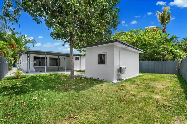 a view of backyard of house with green space