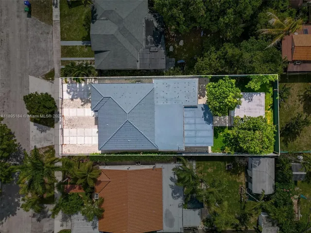 an aerial view of a house with a yard