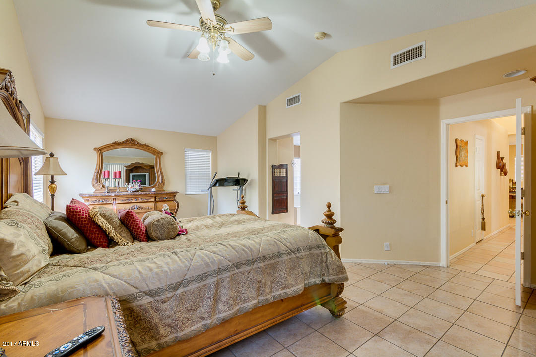 4030 West Cactus Road Phoenix, AZ 85029 - Photo 17 of 29 a bedroom with a large bed and a chandelier